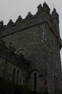 A tower at Glenveagh castle, in a gothic style, harsh and rising in opposition to the natural landscape. 