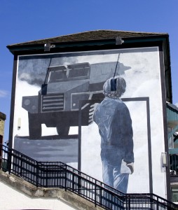 A Mural depicting a citizen of the Bogside watching British Army vehicles occupy the streets. 