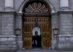 The main entrance to Trinity College, which can only fit two people at a time. Inside, the college green is constructed like a fortress, surrounded by walls and tall buildings that give the appearance of grandeur. 